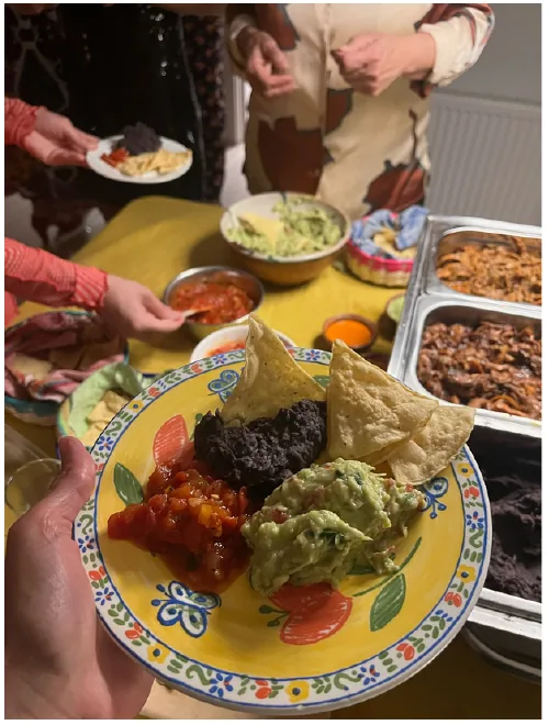 Colourful plate with guacamole, totopos, beans and red salsa